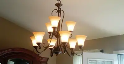 Classic ceiling chandelier installation with warm lighting in Denver, CO