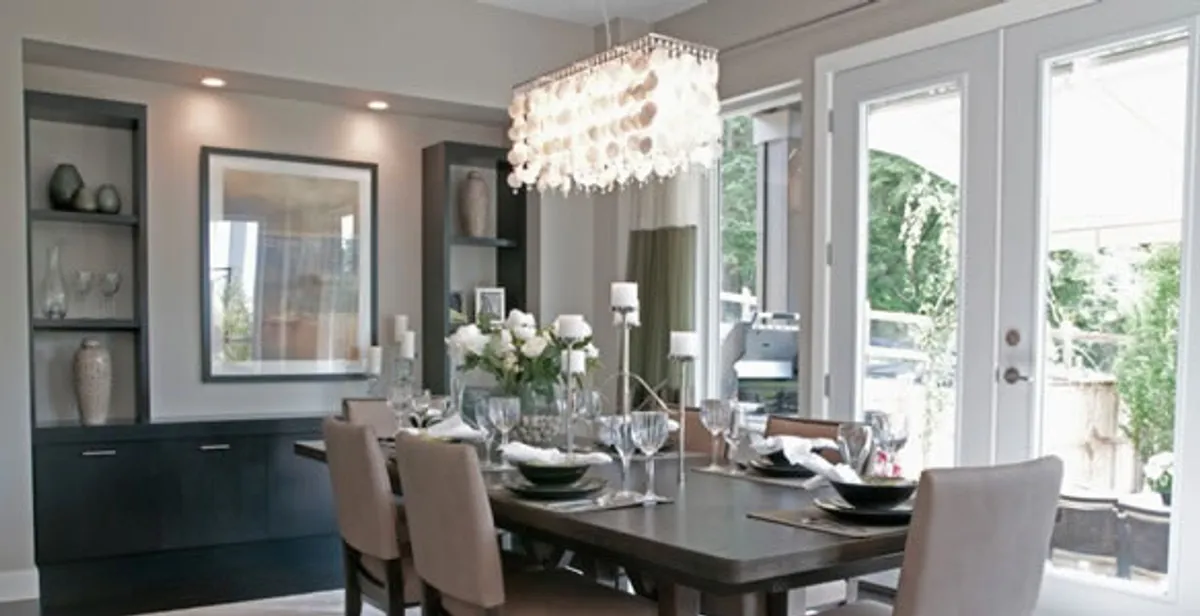 Elegant dining room chandelier installation above table in Denver, CO