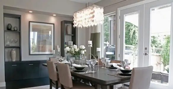 Elegant dining room chandelier installation above table in Denver, CO