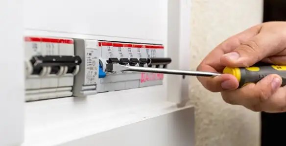 electrical panel upgrade service showing technician adjusting circuit breakers during system upgrade in Denver, CO