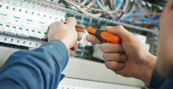 electrical service showing licensed electrician performing electrical panel maintenance and adjustments in Denver, CO