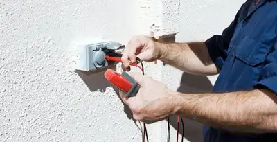 Electrician performing home electrical outlet and wiring inspection in Denver, CO