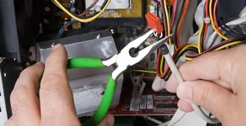 Licensed electrical contractor performing electrical repair with tools in Aurora, CO