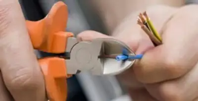 professional electrical services showing precise wire cutting by licensed electricians in Denver, CO