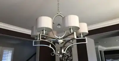 Modern chandelier installation with multiple light fixtures in Denver, CO