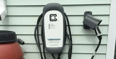Outdoor electric vehicle charger installation on residential wall in Denver, CO