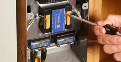 Whole home surge protection device being installed by a licensed electrician to protect electrical systems in Denver, CO
